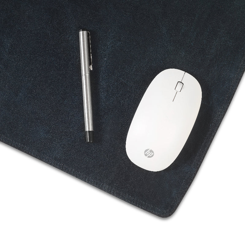 White HP mouse and silver pen on a dark mouse pad
