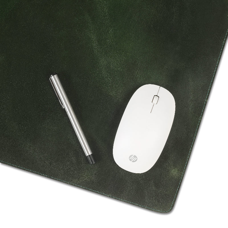 Black leather desk mat with a pen and white mouse on a white background