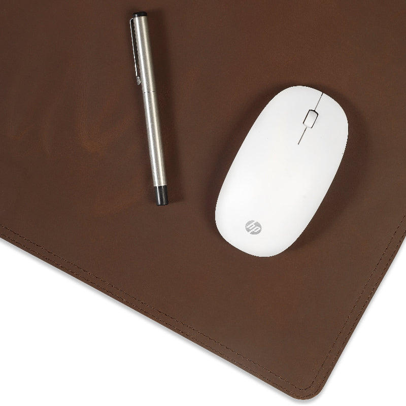 White HP mouse and pen on a brown mouse pad