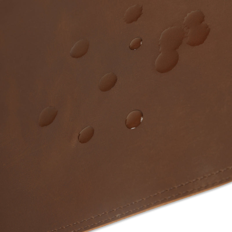 Close-up of a brown leather desk mat with embossed patterns