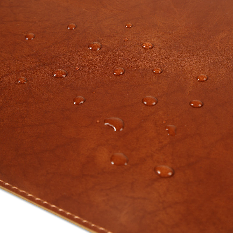 Brown leather surface with water droplets