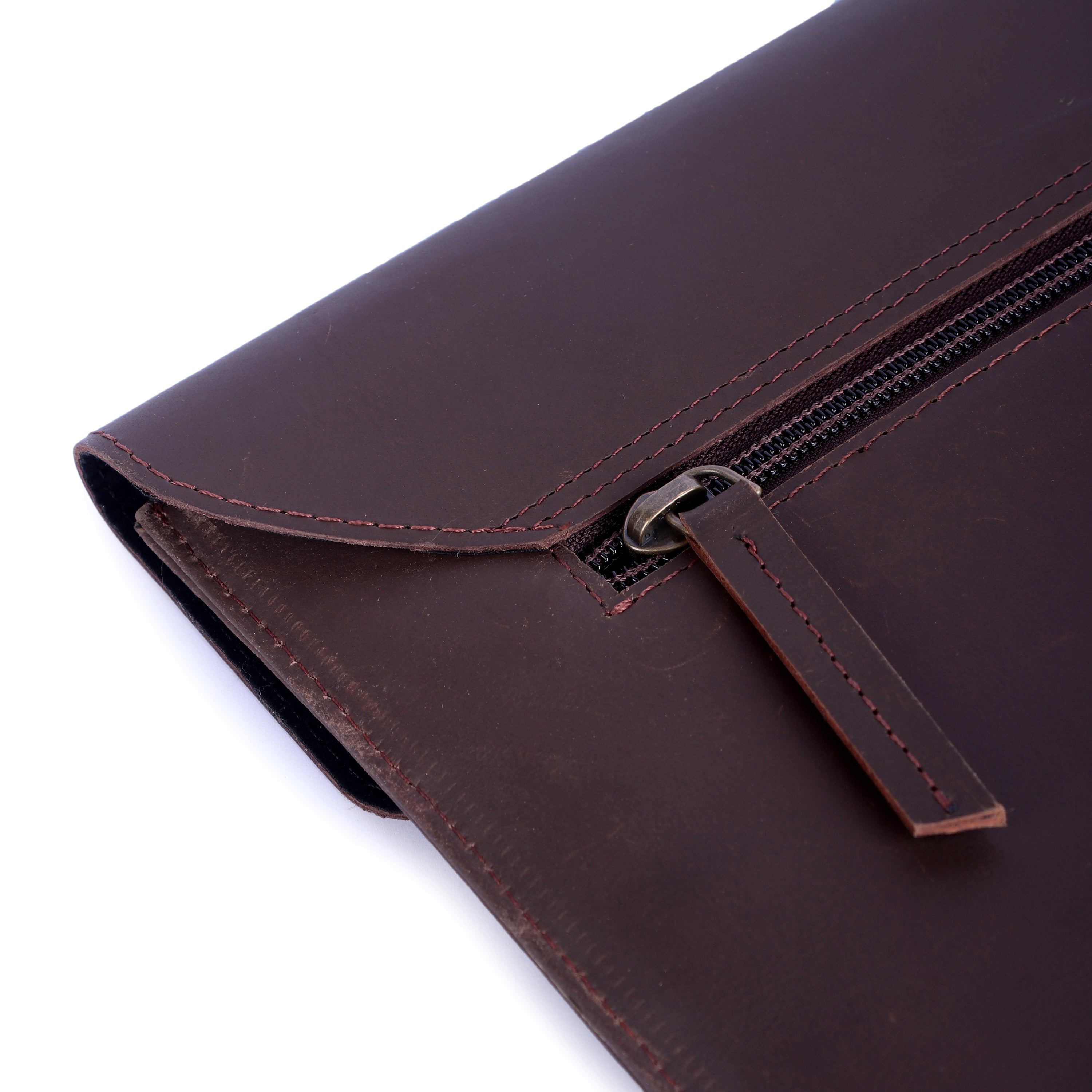 Brown leather clutch bag with a zipper on a white background
