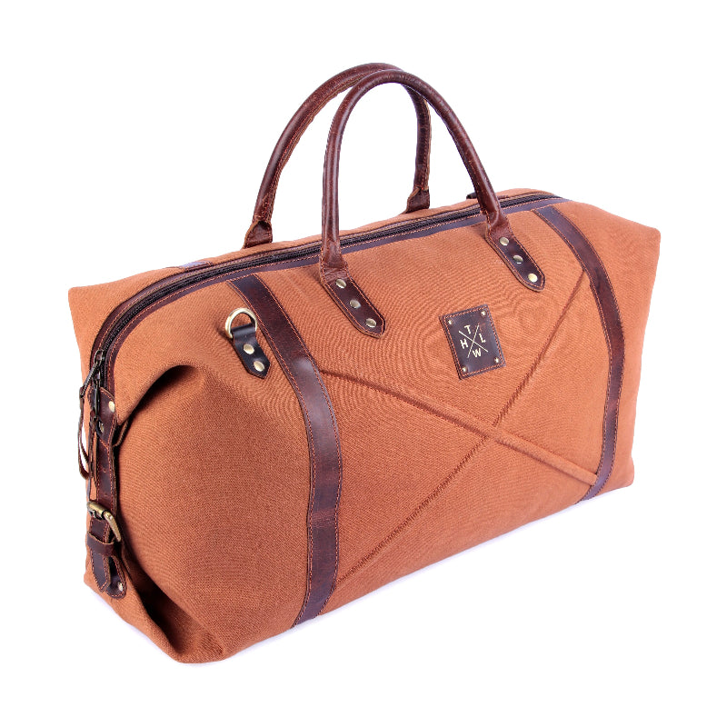 Brown travel bag with leather straps on a white background