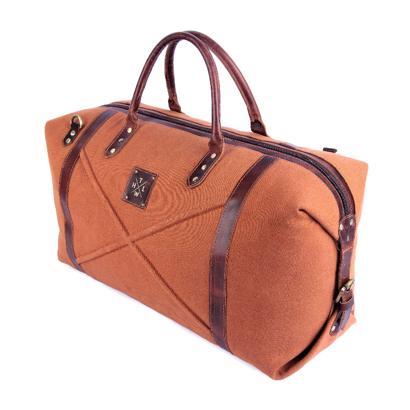 Brown travel bag with leather straps on a white background