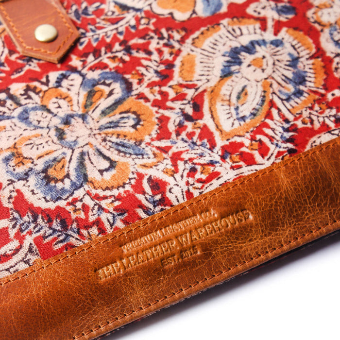 Close-up of a floral-patterned sleeve with brown leather trim, featuring the brand 'Sheaffer Warehouse'.