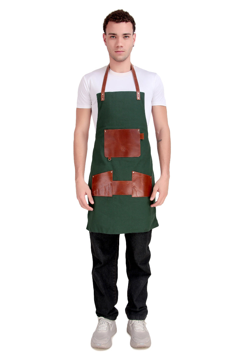Man wearing a green apron with brown leather accents on a white background