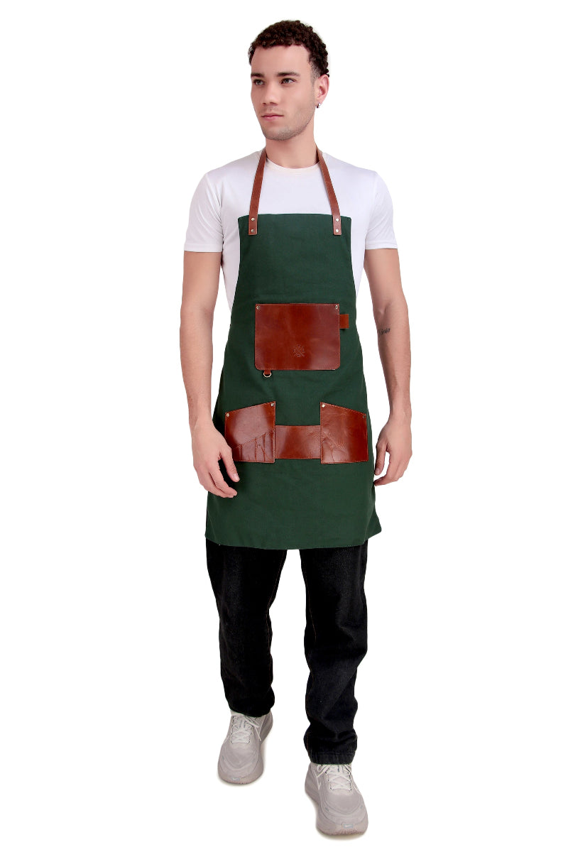 Man wearing a green apron with brown leather pockets on a white background