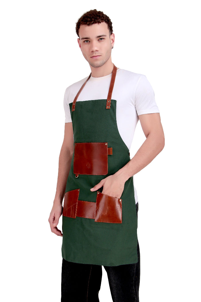 Man wearing a green apron with brown leather accents on a white background