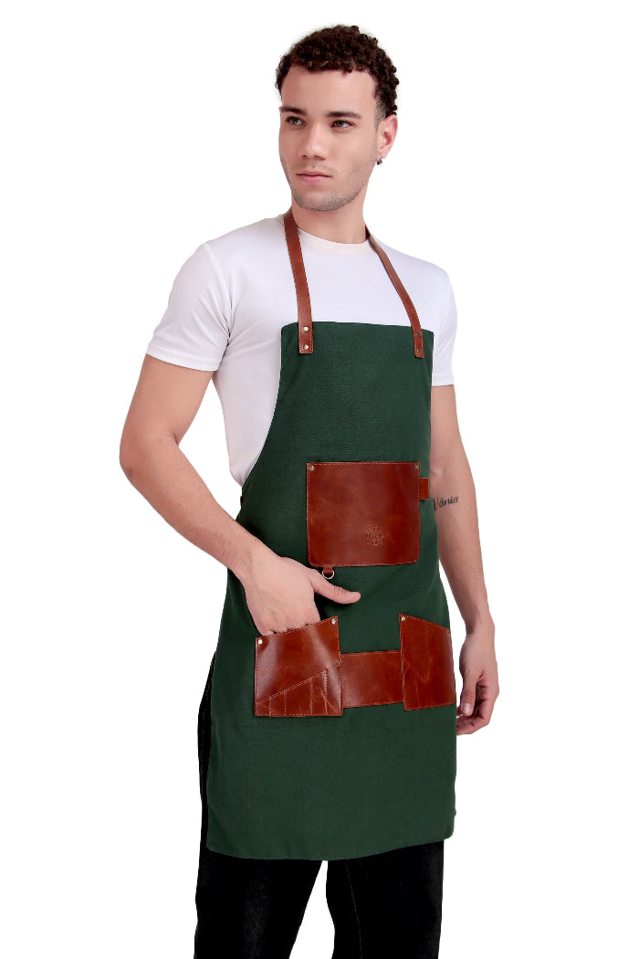 Man wearing a green apron with brown leather pockets on a white background
