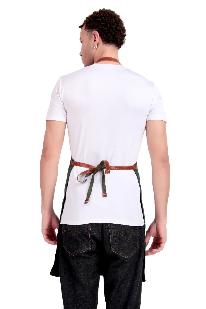 Person wearing a white shirt and black apron with a brown belt on a white background