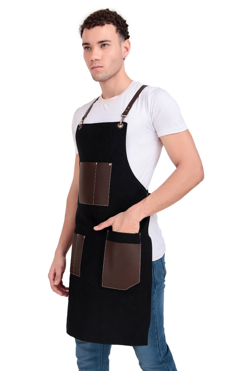 Man wearing a black apron with brown leather pockets on a white background