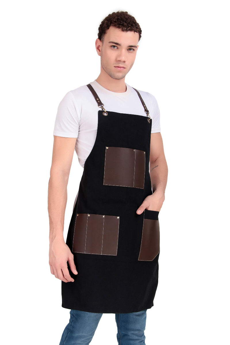 Man wearing a black apron with brown leather pockets on a white background