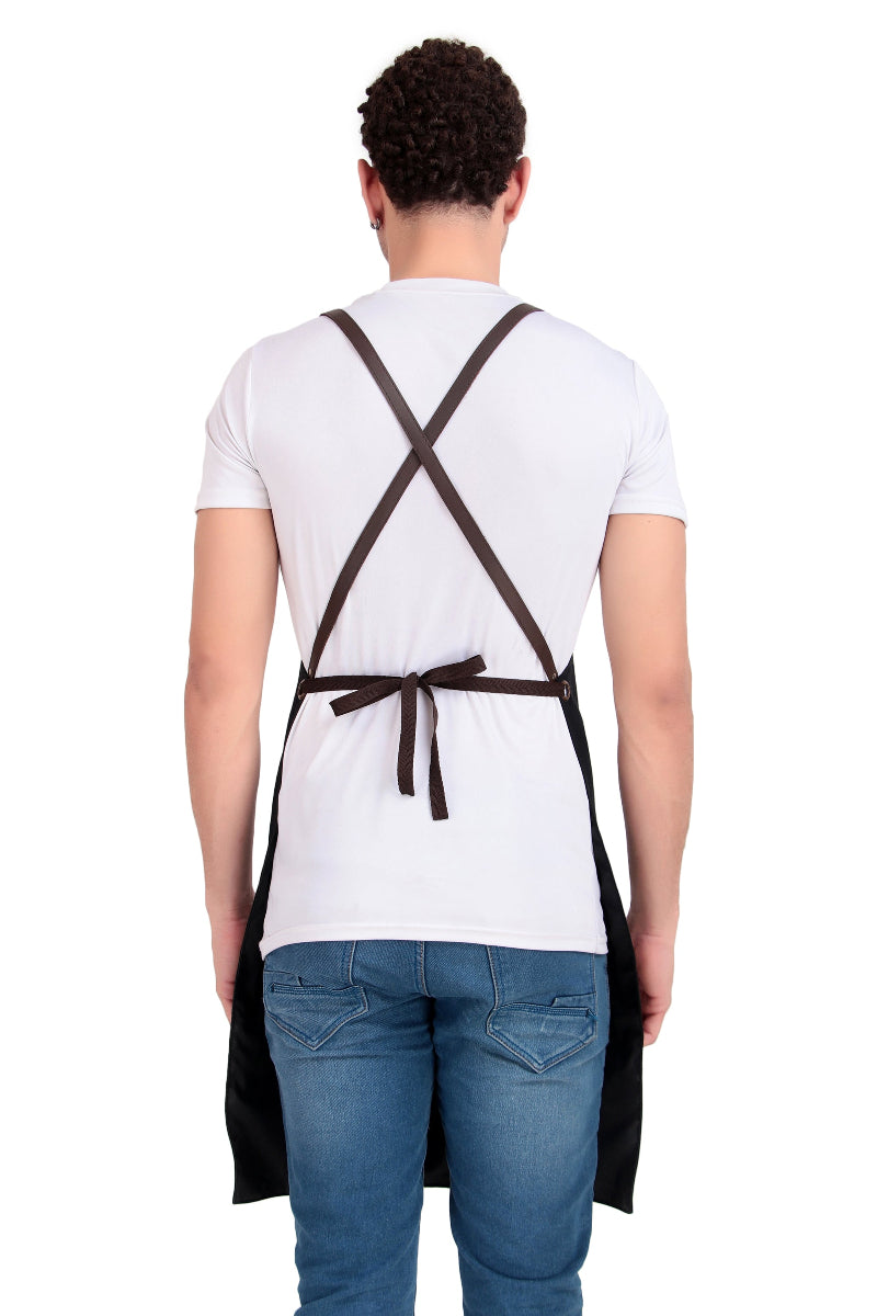 Person wearing a black apron with cross straps on a white background