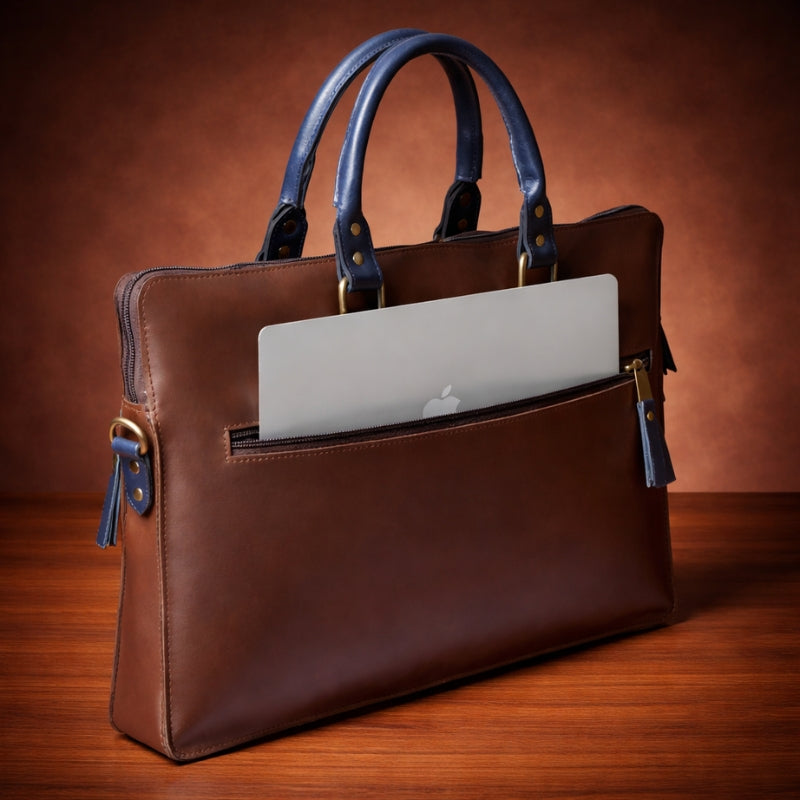 Brown leather briefcase with a laptop inside on a wooden surface