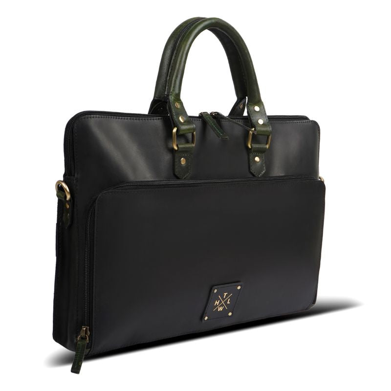 Black handbag with green handles on a white background