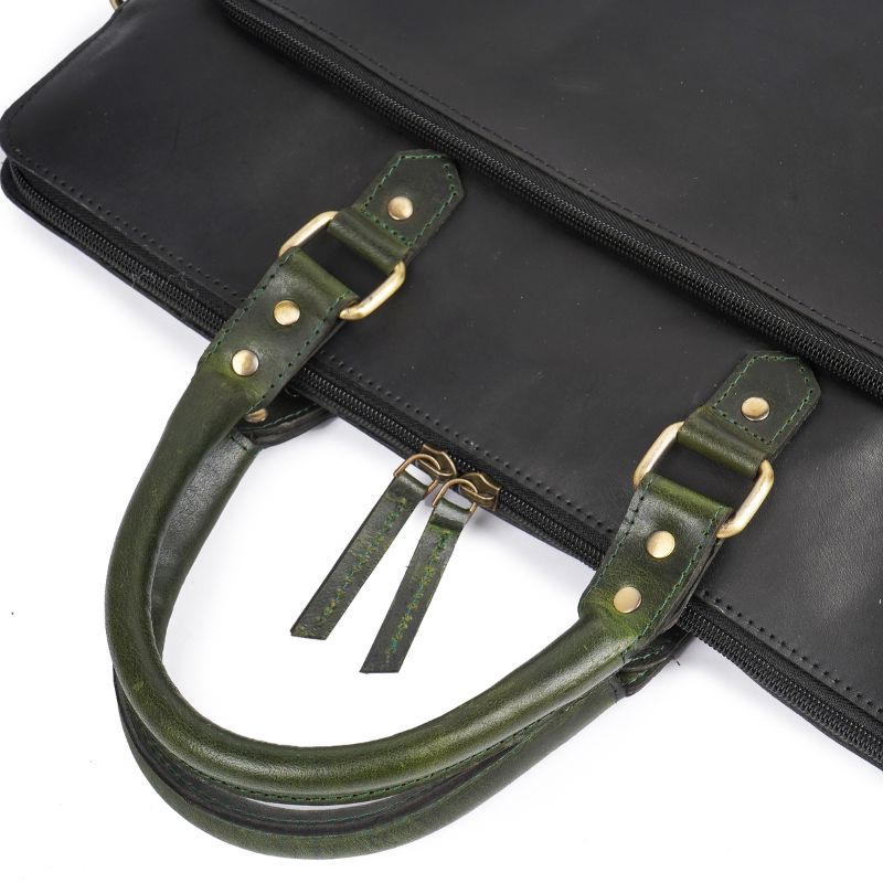 Black briefcase with green leather handles on a white background