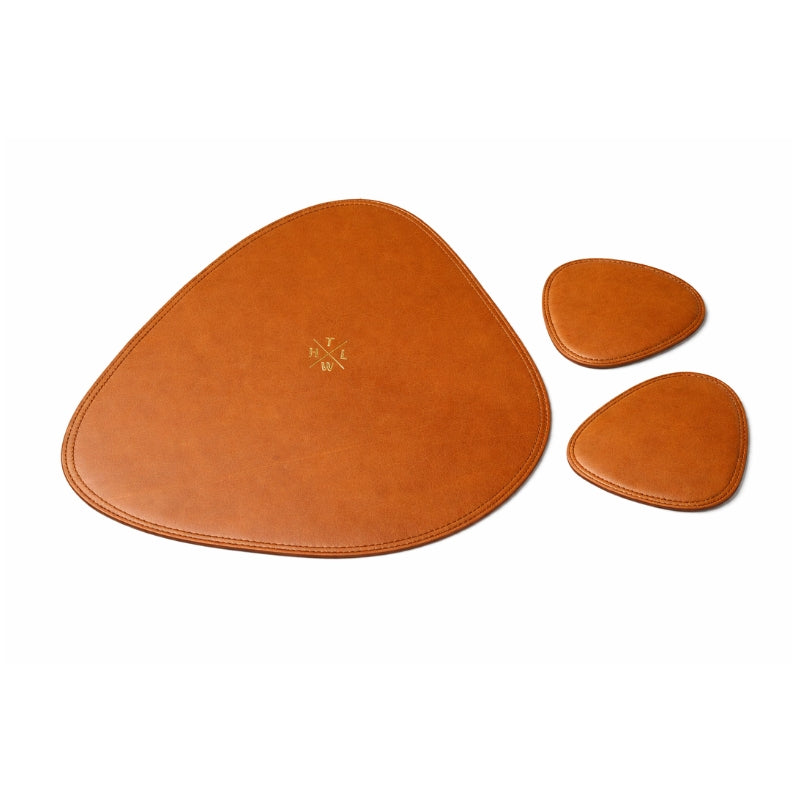 Set of three brown leather coasters on a white background
