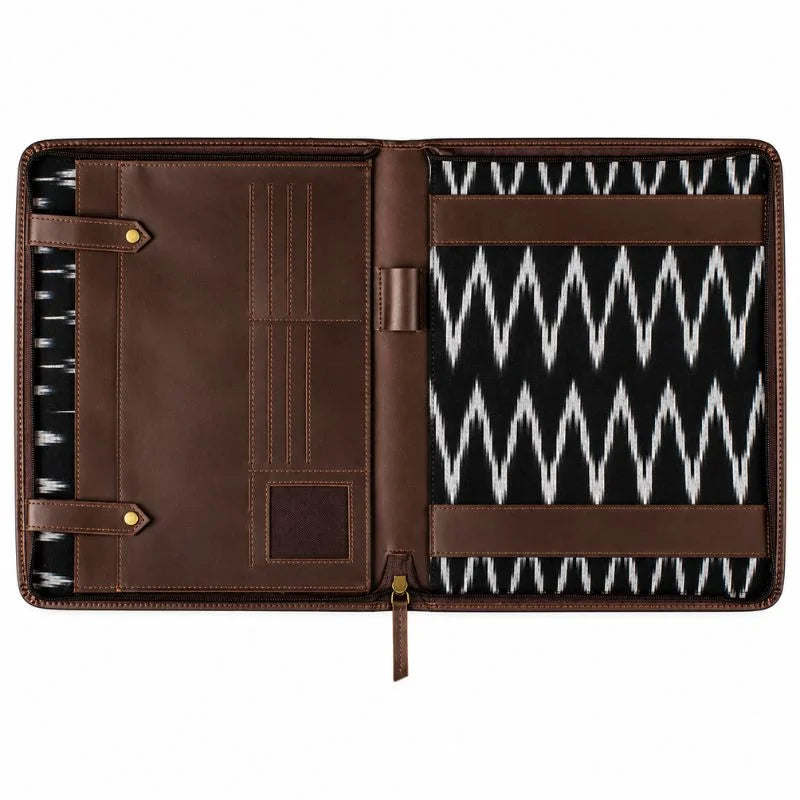 Open brown leather portfolio with black-and-white ikat fabric lining.