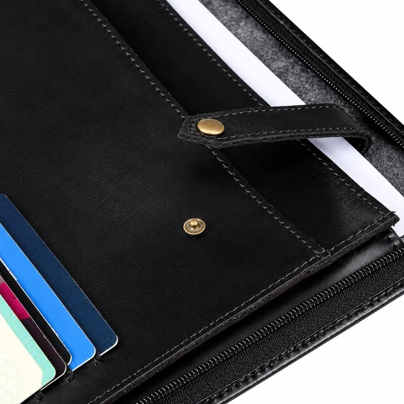 Open black leather zippered portfolio with a notepad held by elastic straps on the right, and card slots