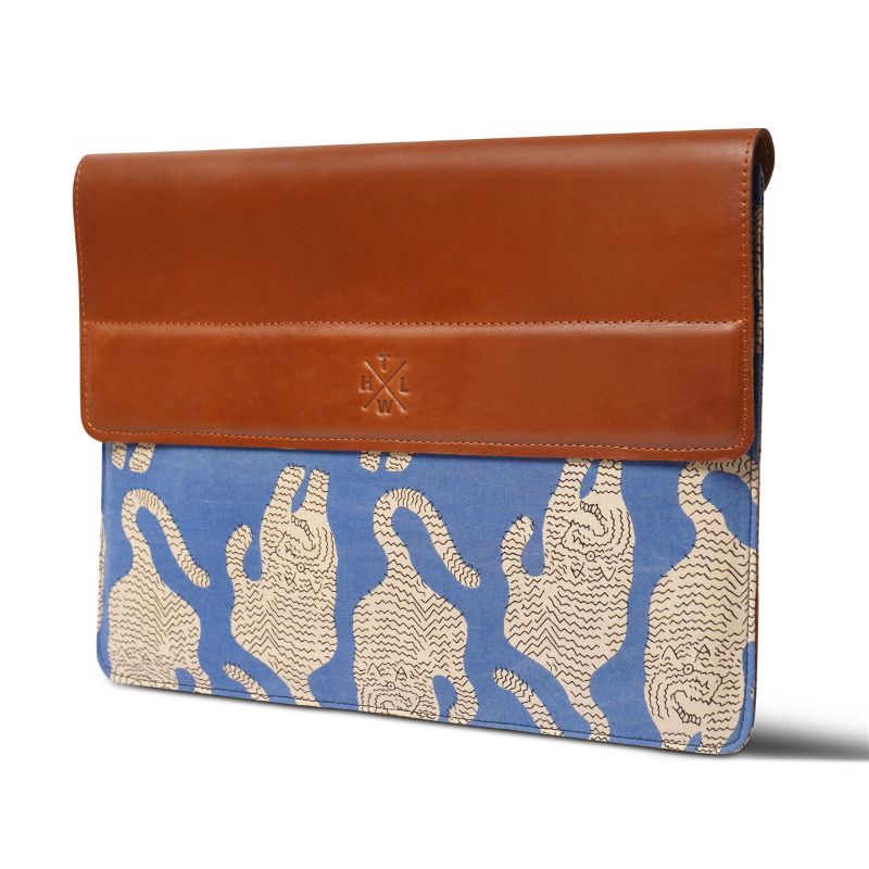 laptop sleeve with brown top section and blue base featuring animal pattern on a white background