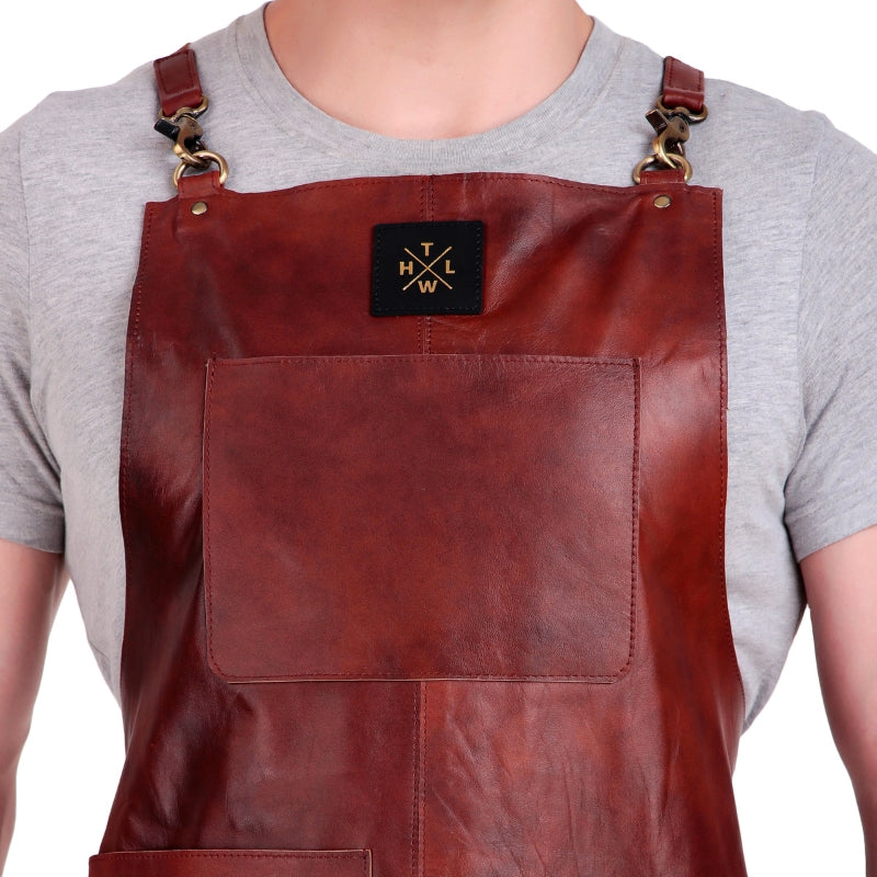 Brown leather apron with a brand logo on a white background