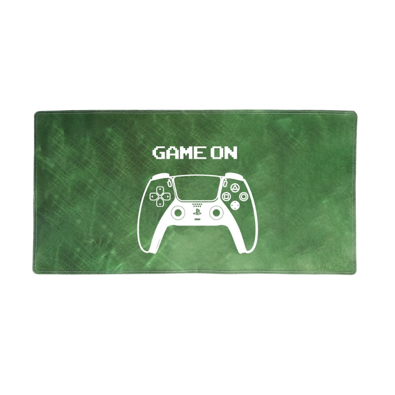 Green gaming desk/mouse pad with white controller design and 'GAME ON' text on a white background