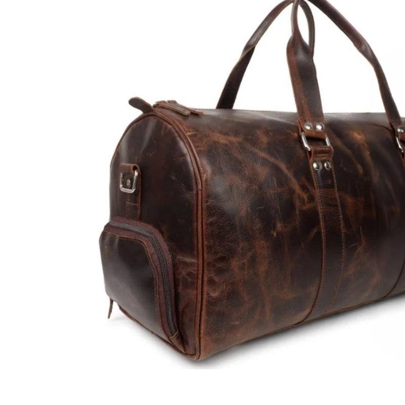 Brown leather duffel bag on a white background