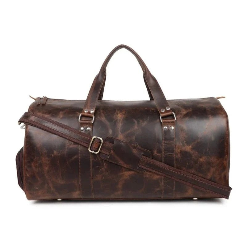Brown leather duffel bag with straps on a white background