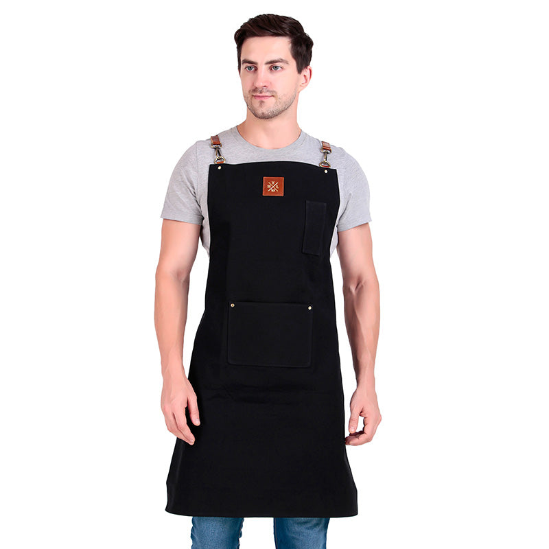 Man wearing a black apron with a brand logo on a white background