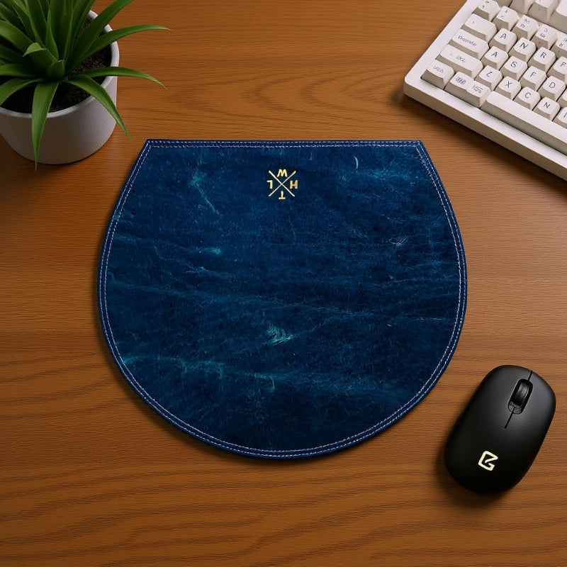 Blue mouse pad with a logo on a wooden desk with a keyboard and mouse.