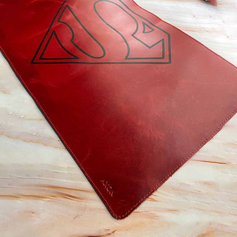 Red mat with a black logo on a light wooden surface