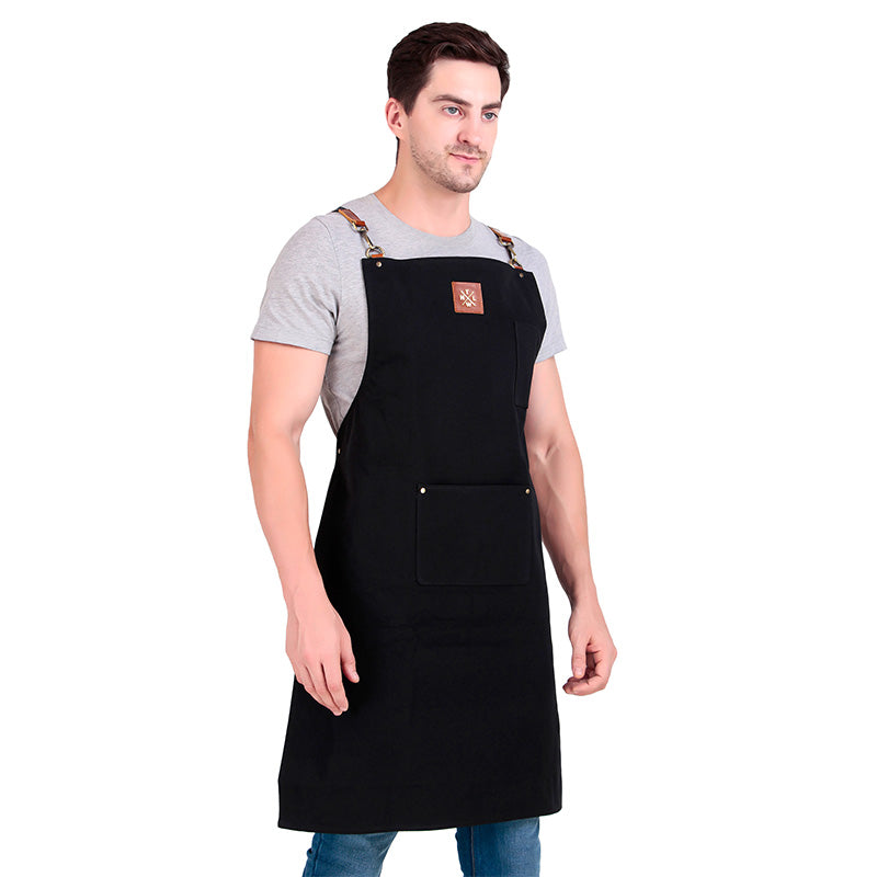 Man wearing a black apron with a logo on a white background