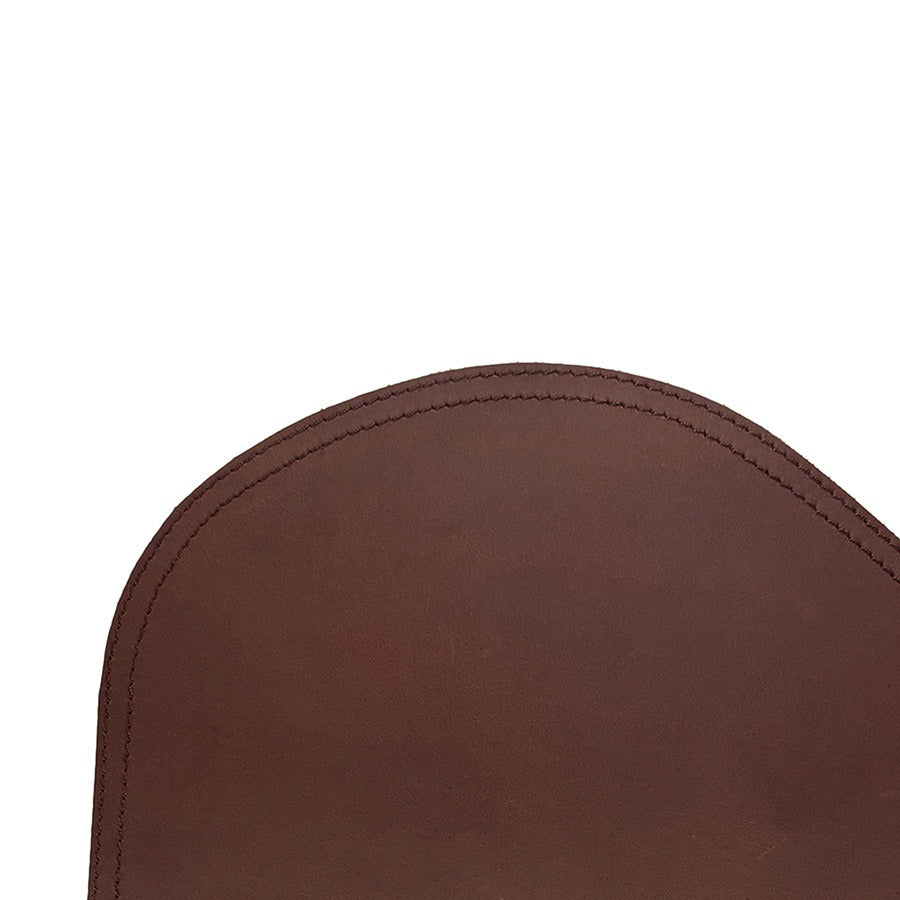 Close-up of a brown leather chair seat on a white background