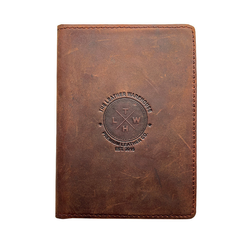 Brown leather notebook with embossed logo on a white background