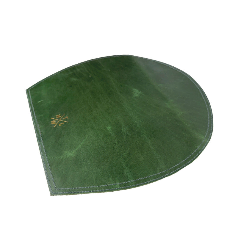 Green leather saddle pad on a white background