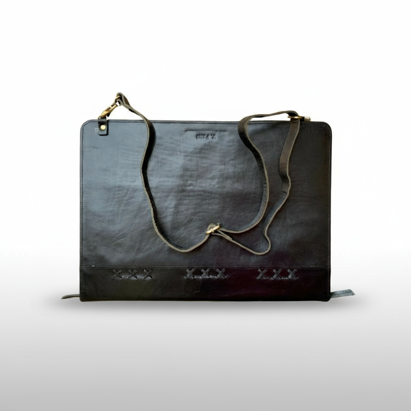 Black leather handbag with gold accents on a white background