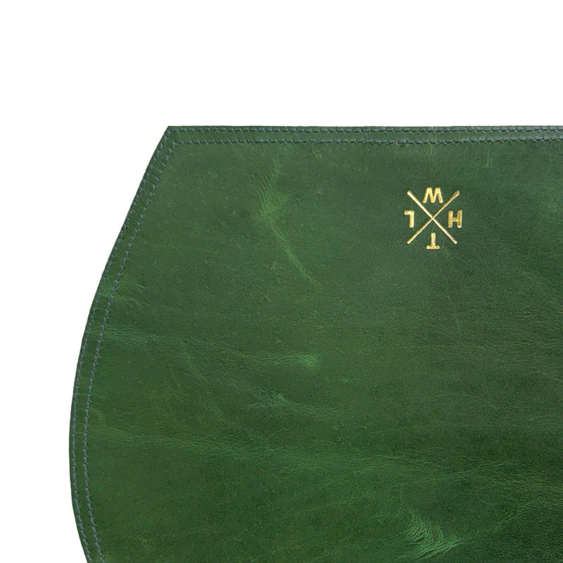 Green leather clutch with gold logo on a white background