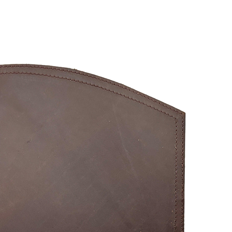 Close-up of a brown leather product with visible stitching on a white background