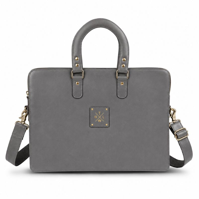 Gray leather laptop bag with gold accents on a white background