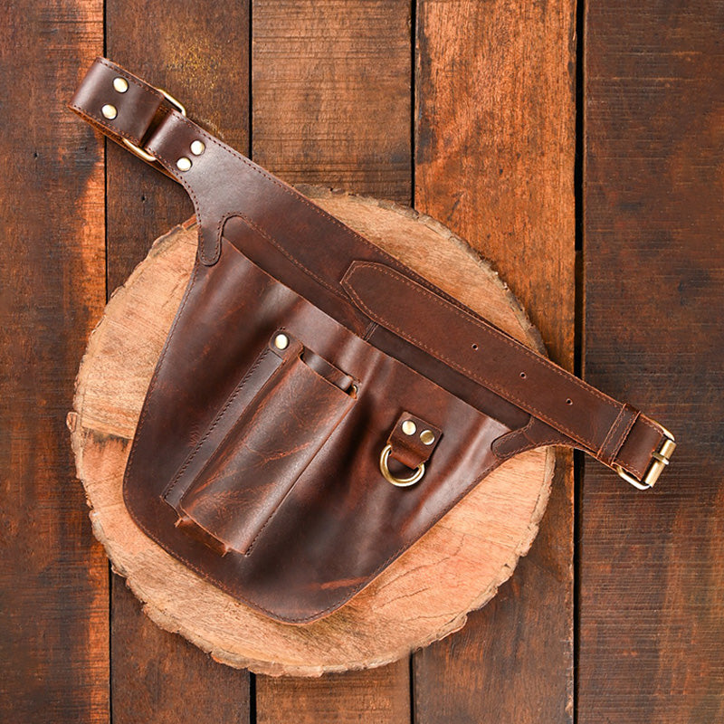 Brown leather waist bag on a wooden surface