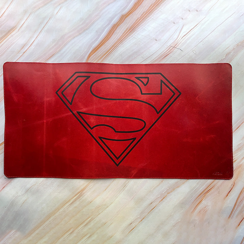 Red mat with Superman logo on a marble surface