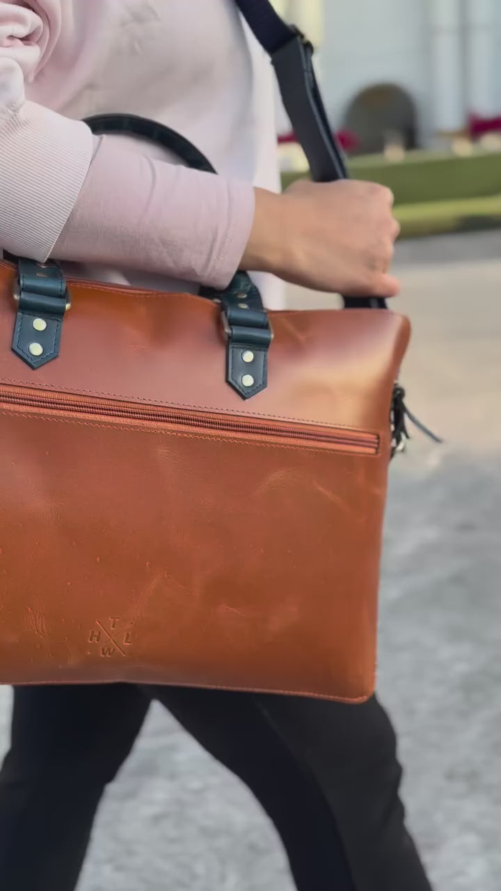women handling laptop leather bag