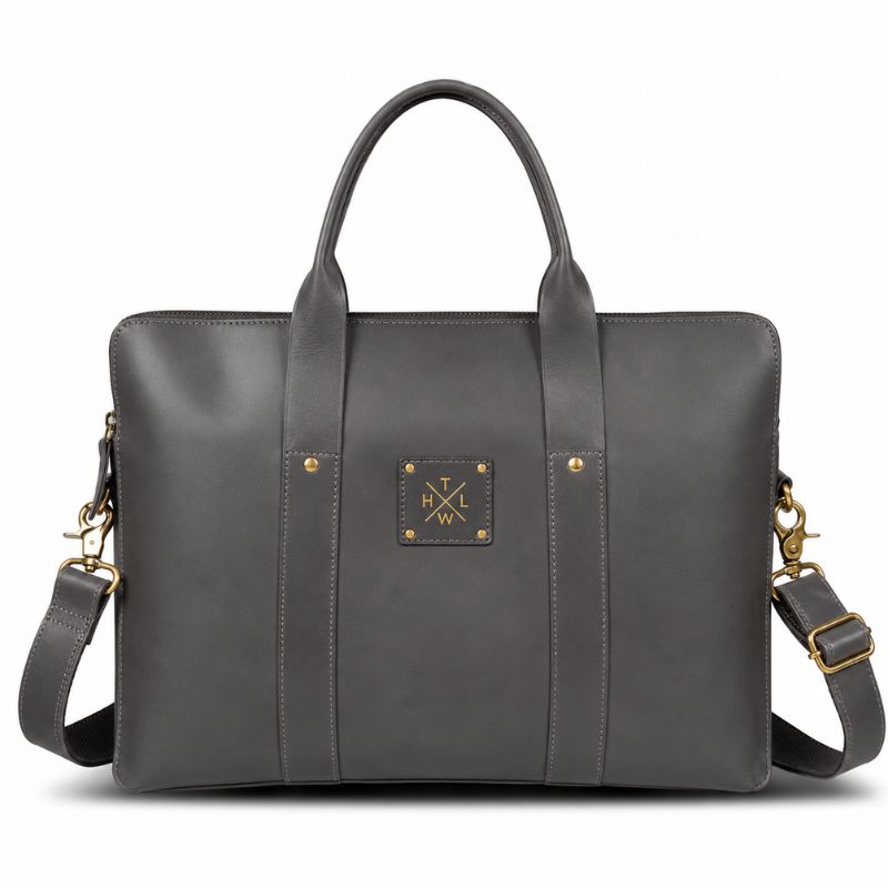 Gray leather laptop bag with gold accents on a white background