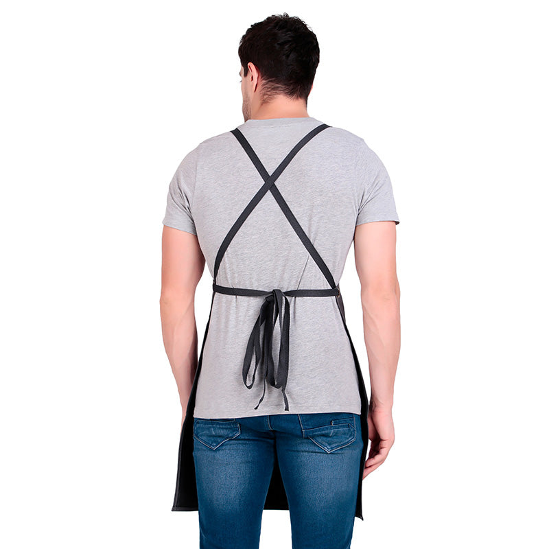 Person wearing a black apron over a gray t-shirt on a white background