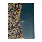 Blue leather clutch with floral patterned interior on a white background