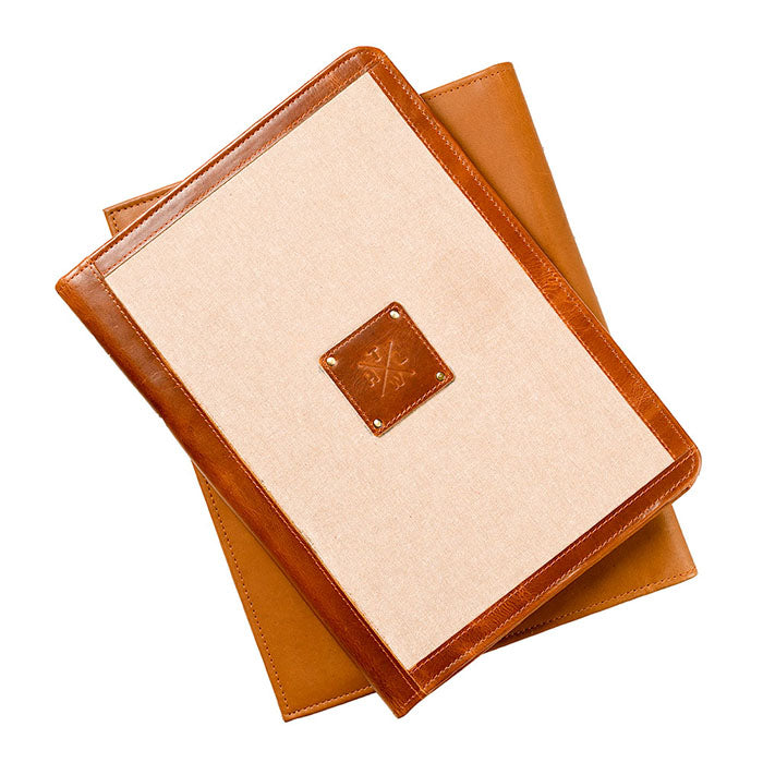 Two tan brown leather and canvas file folders stacked together, featuring a stitched leather patch with The Leather Warehouse logo on the cover.