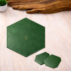 Hexagonal green placemat with coasters on a wooden surface