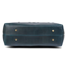 Blue leather bag with gold studs on a white background