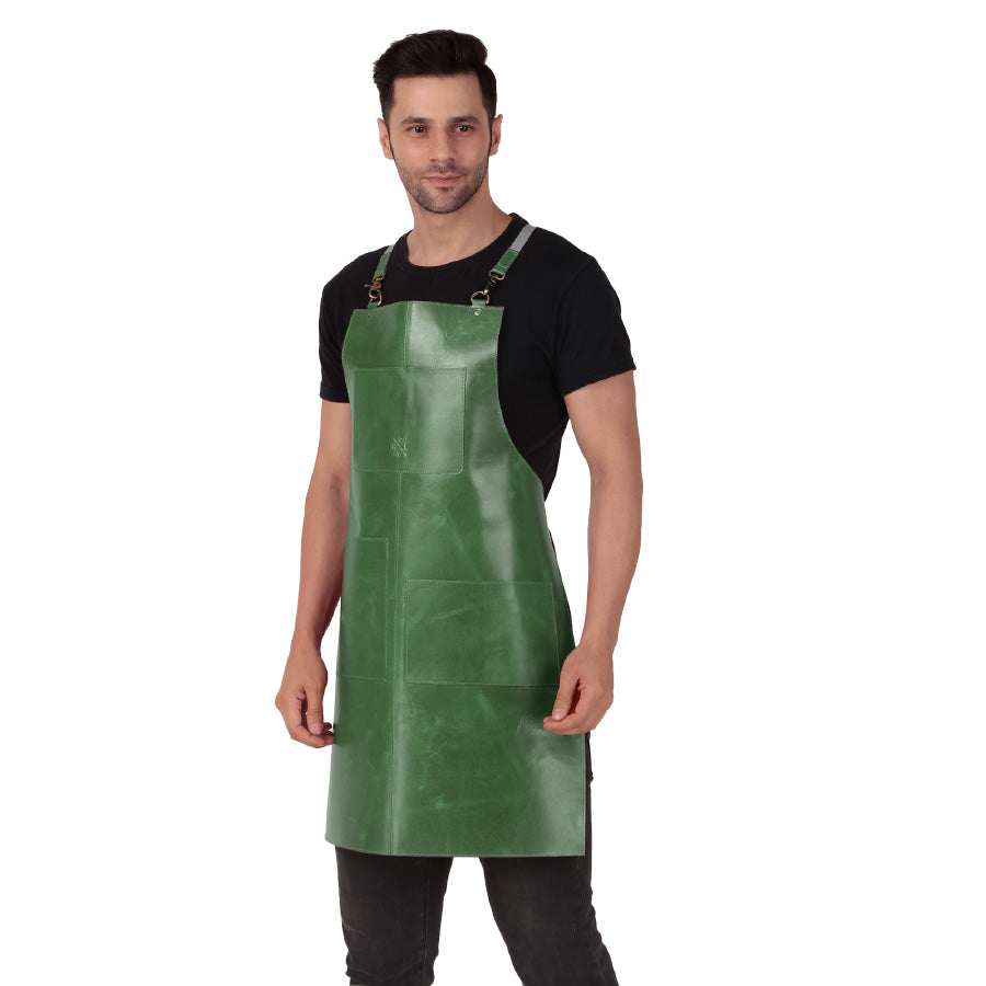 Man wearing a green leather apron with adjustable straps, posing against a white background.