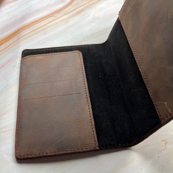 Brown leather wallet on a marble surface